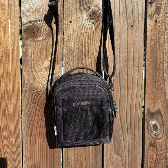 Pacsafe® LS100 anti-theft crossbody bag - black ECONYL® regenerated nylon - Picture 1 of 11